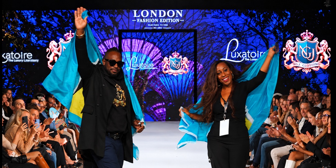 Saint Lucian fashion representatives on the London runway with Saint Lucia flags and NGU Clothing and LUXATOIRE branding